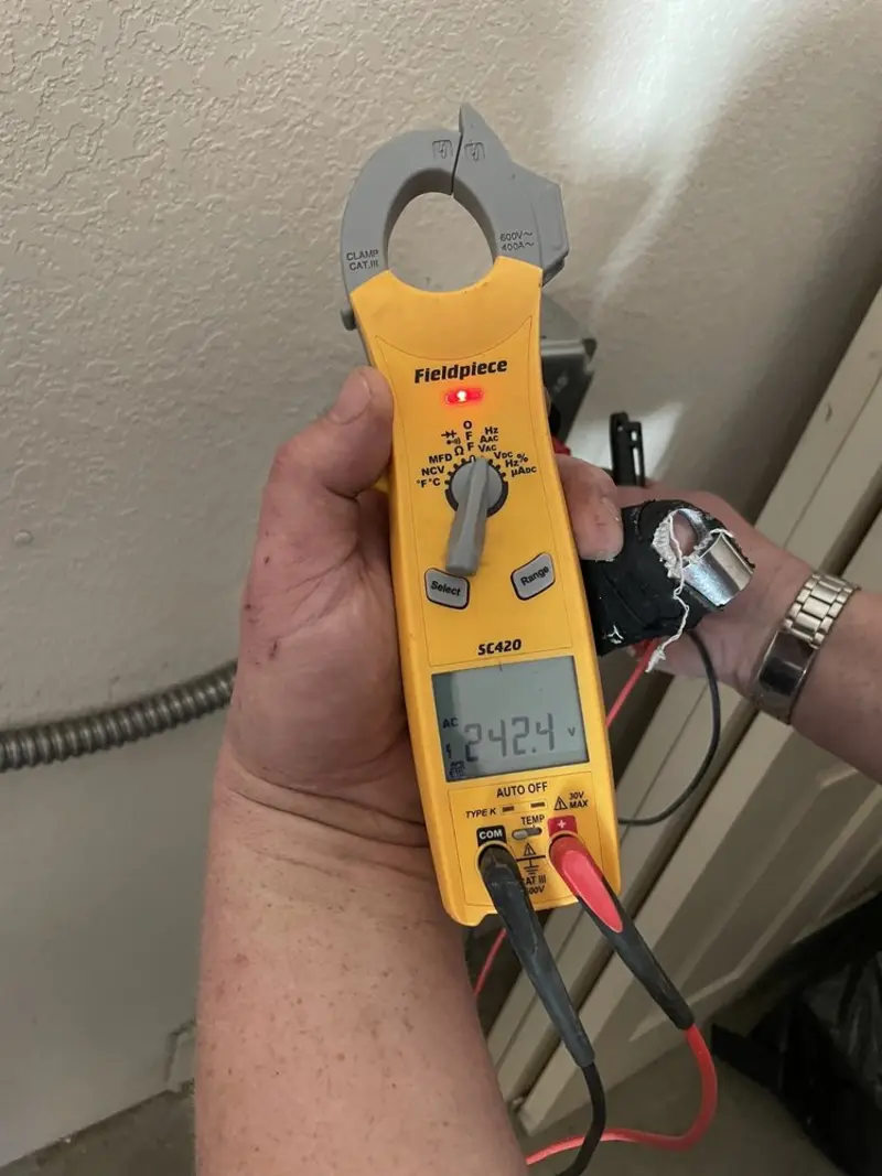Voltage testing with clamp meter during Electrical Installation Services in Needville